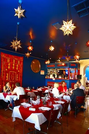 Red tablecloths under star lanterns at Marrakech